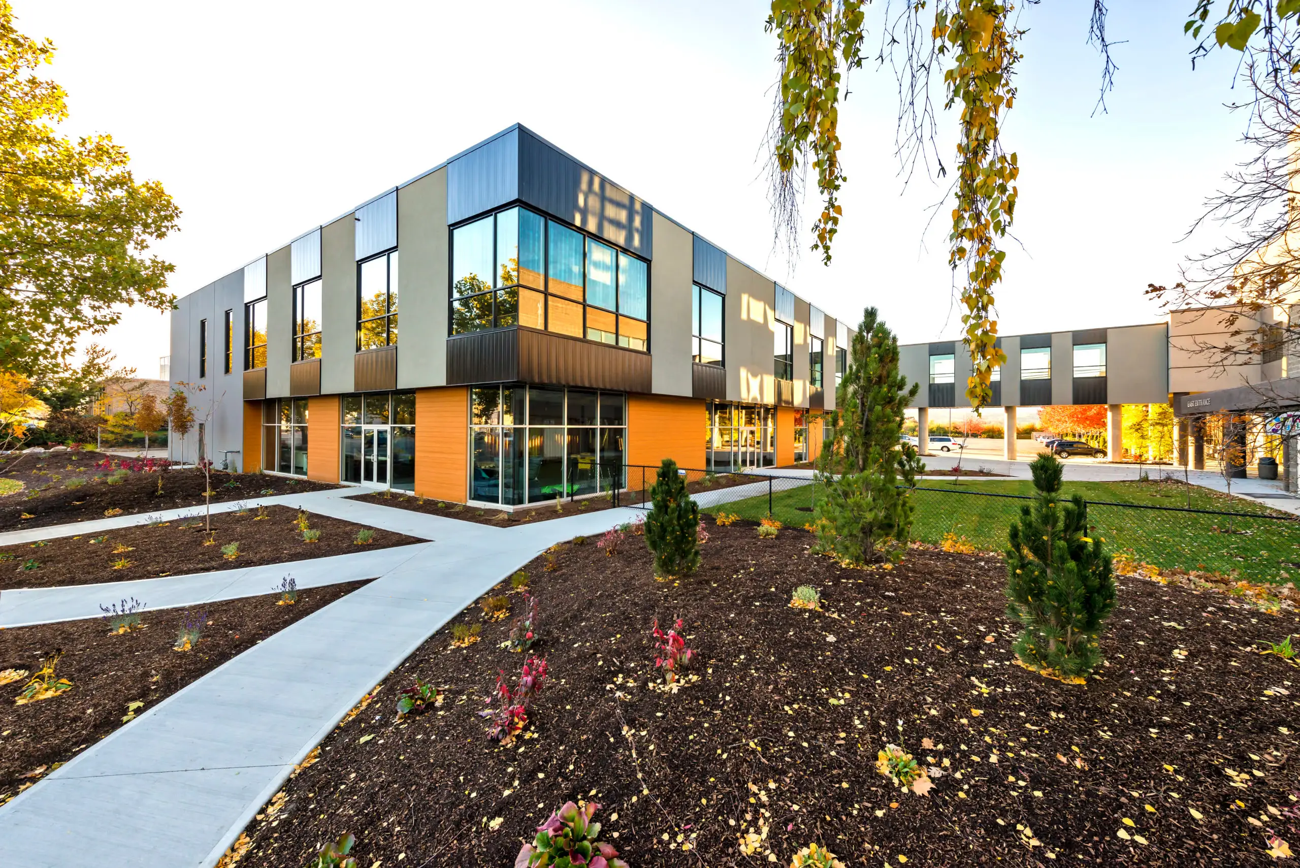 The Refinery commercial building in Kelowna at golden hour, built by Chriscan Construction